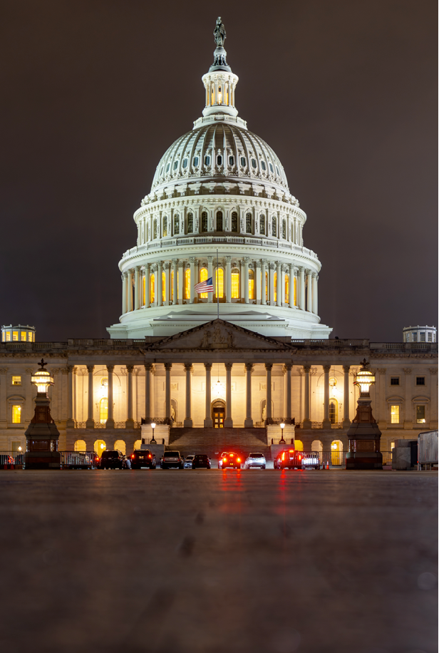 illuminated U.S. Capitol building at night showcasing iconic architecture and large-scale public space design